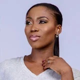 Funmi-Ayowole a person with the hand on the chest
