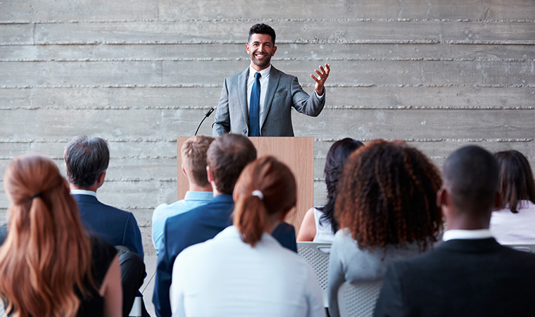 a person speaking to a group of people